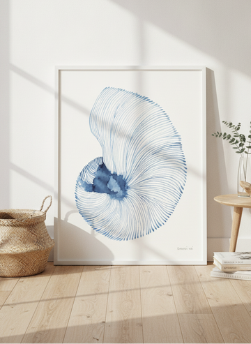 Oversized statement modern wall art print leaning against the wall in a coastal bedroom
