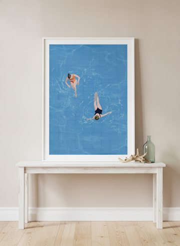 Modern wall art print standing on a console in a coastal bedroom