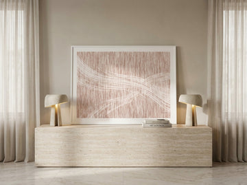 Modern wall art print standing on a console in a luxe bedroom