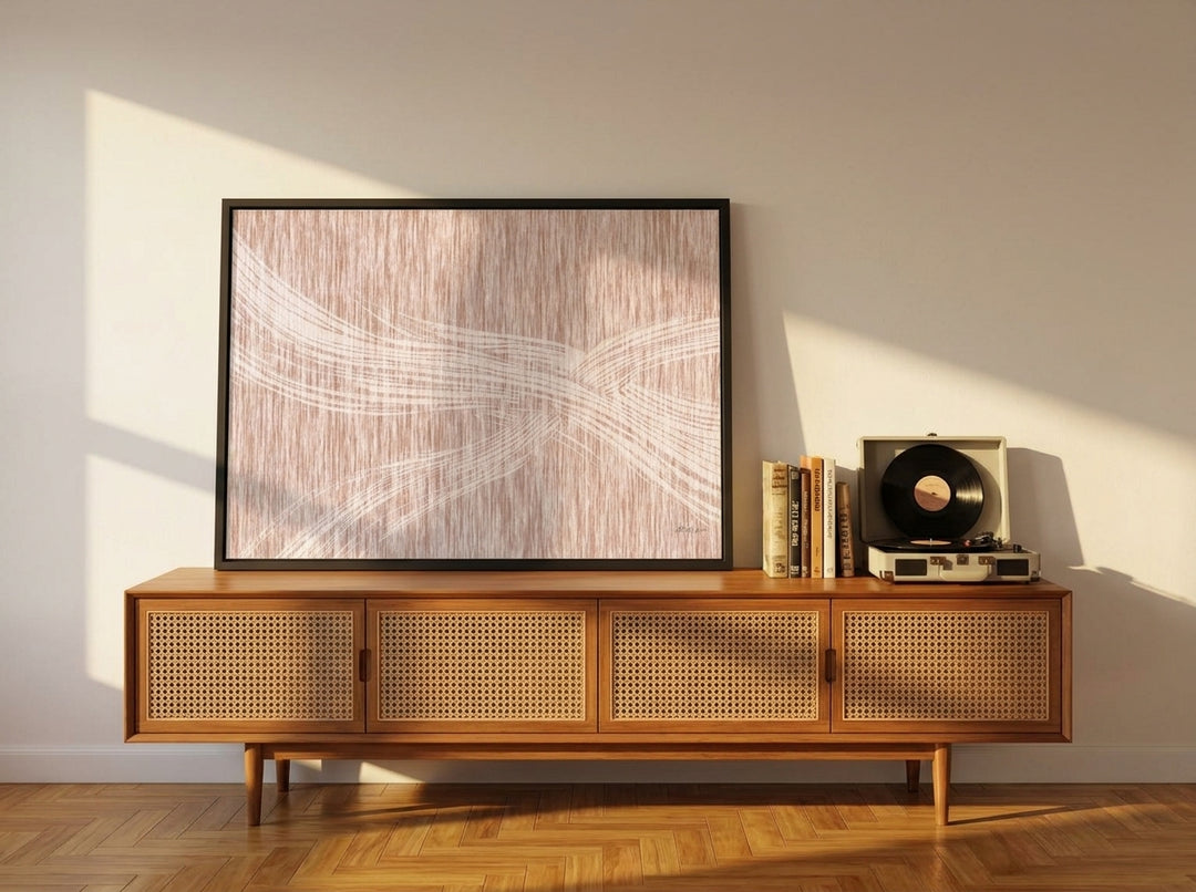 Modern wall art print standing on a sideboard in a mid-century living room