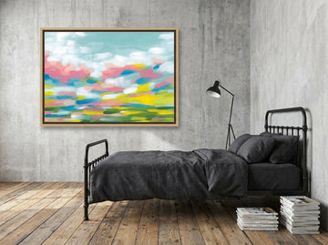 Canvas wall art with a natural timber surround styled on the wall in an industrial loft bedroom