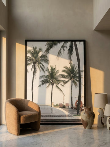 Oversized statement modern wall art print leaning against the wall in a luxe dining room
