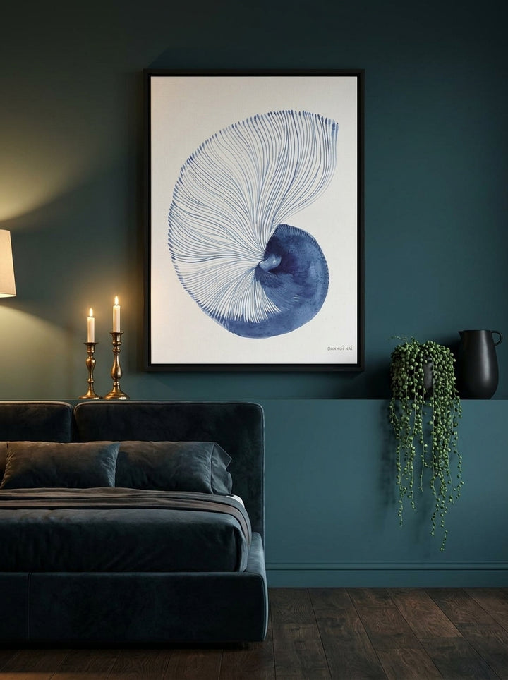 Canvas wall art with a black surround styled on the wall in a moody bedroom