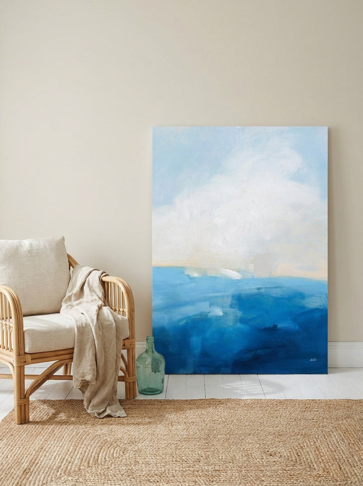 Stretched canvas wall art leaning against the wall in a coastal living room