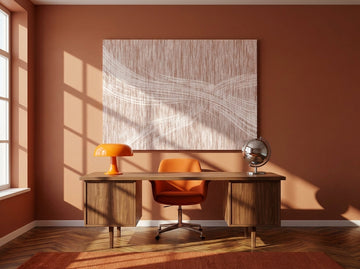 Stretched canvas wall art styled on the wall in a retro 70s home office
