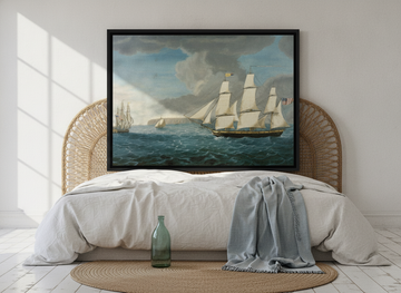 Canvas wall art with a black surround styled on the wall in a coastal bedroom