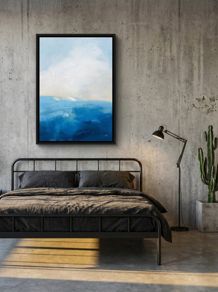 Canvas wall art with a black surround styled on the wall in an industrial loft bedroom