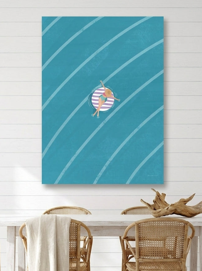 Stretched canvas wall art styled on the wall in a coastal dining room