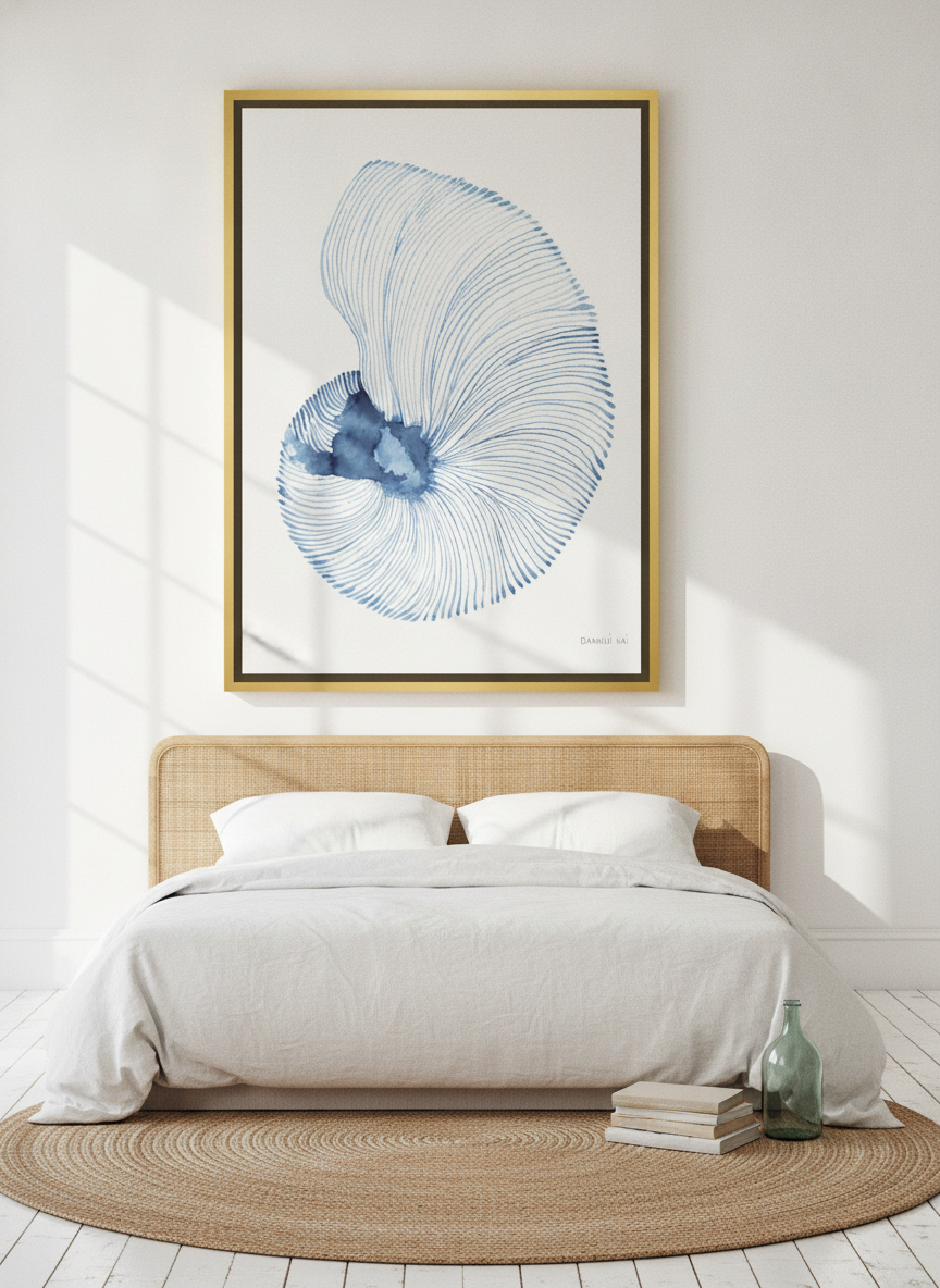 Oversized statement canvas wall art with a gold leaf surround styled on the wall in a coastal bedroom