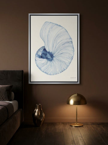 Canvas wall art with a silver leaf surround styled on the wall in a moody bedroom