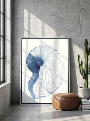 Canvas wall art with a silver leaf surround leaning against the wall in an industrial loft living room