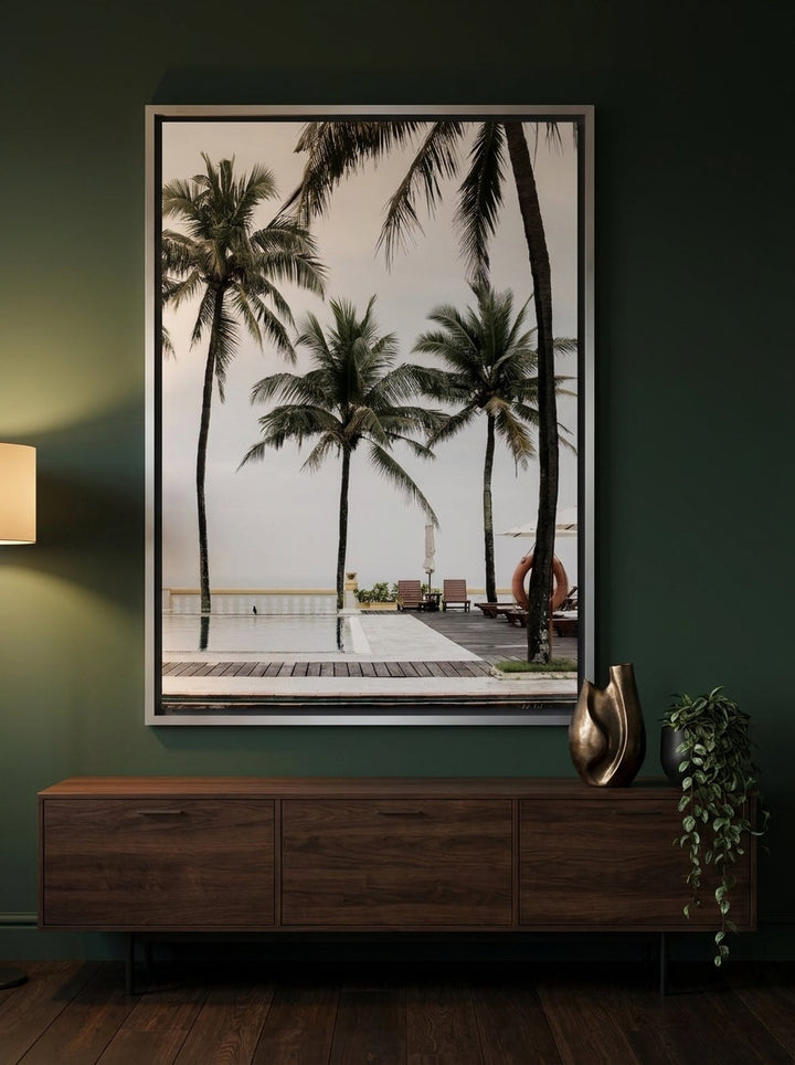 Oversized statement canvas wall art with a silver leaf surround styled on the wall in a moody living room