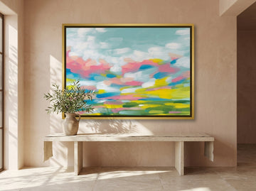 Oversized statement canvas wall art with a gold leaf surround styled on the wall in a Mediterranean living room