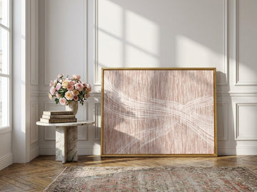 Canvas wall art with a gold leaf surround leaning against the wall in a Parisian home office