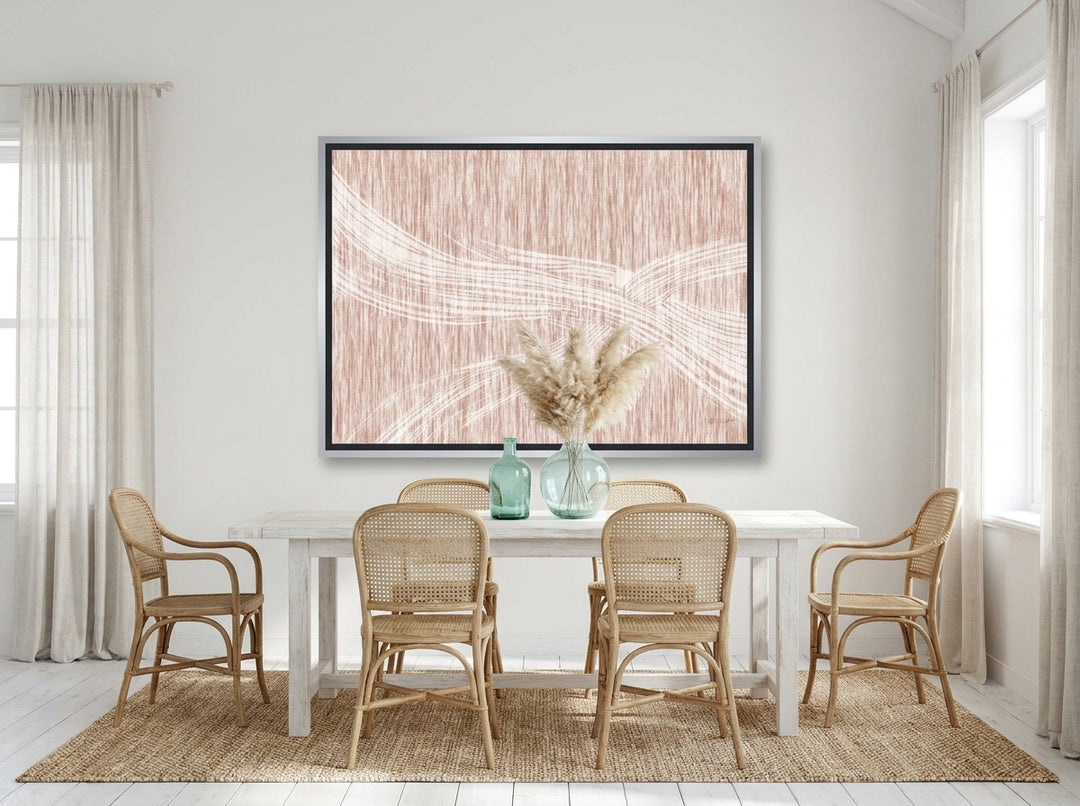 Oversized statement canvas wall art with a silver leaf surround styled on the wall in a coastal dining room
