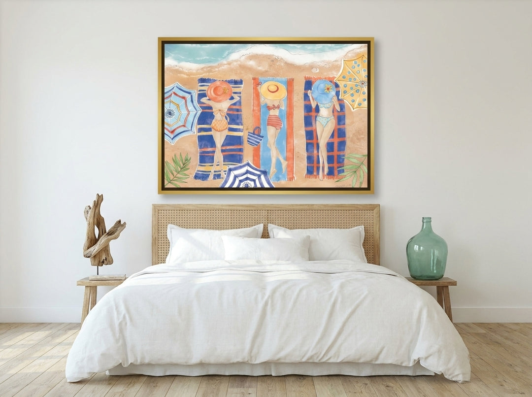 Canvas wall art with a gold leaf surround styled on the wall in a coastal bedroom