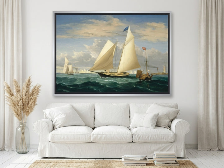 Oversized statement canvas wall art with a silver leaf surround styled on the wall in a coastal living room