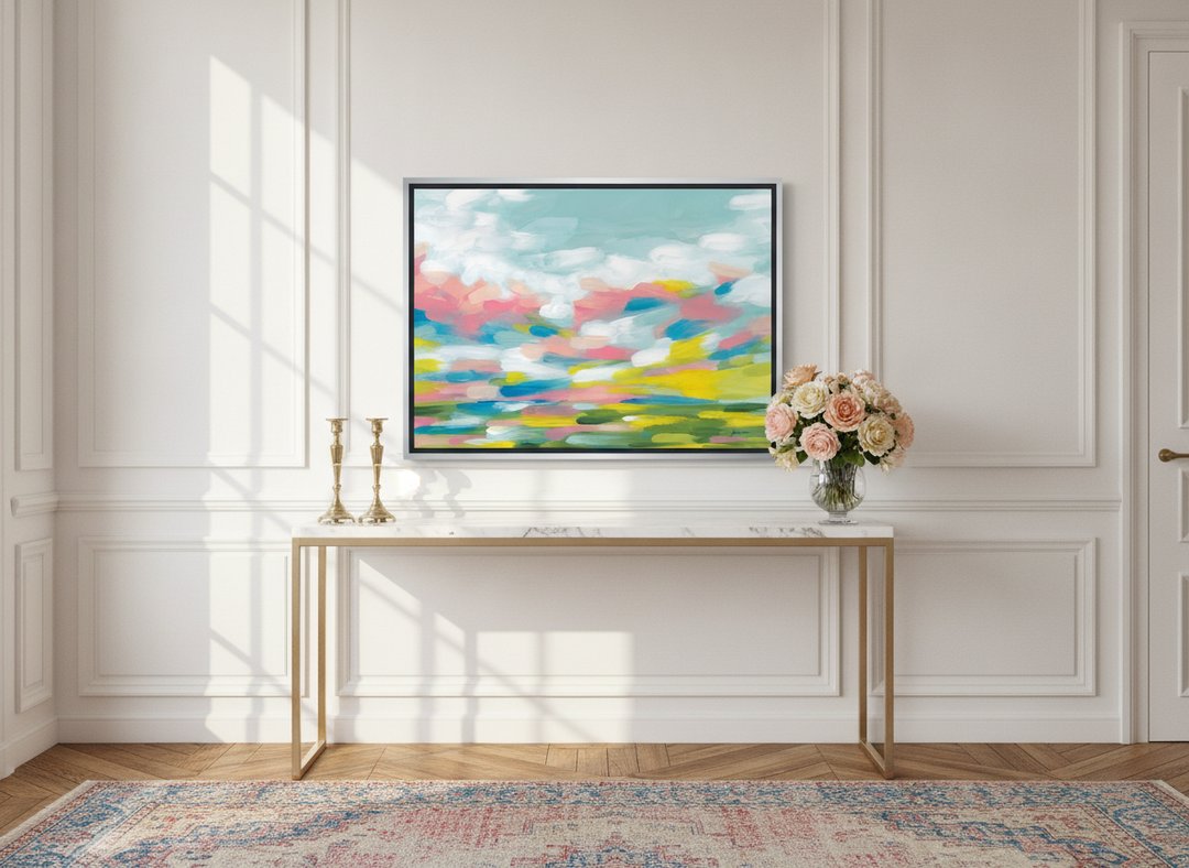 Canvas wall art with a silver leaf surround standing on a console in a Parisian home office