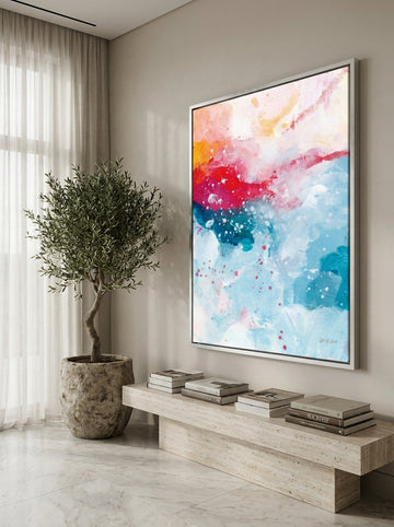 Oversized statement canvas wall art with a silver leaf surround styled on the wall in a luxe living room