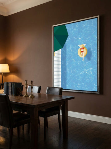 Oversized statement canvas wall art with a silver leaf surround styled on the wall in a moody dining room