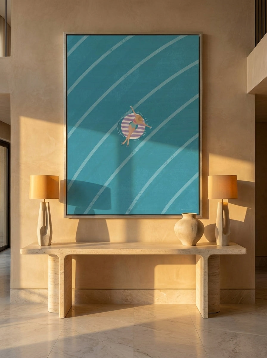Oversized statement canvas wall art with a silver leaf surround styled on the wall in a luxe living room