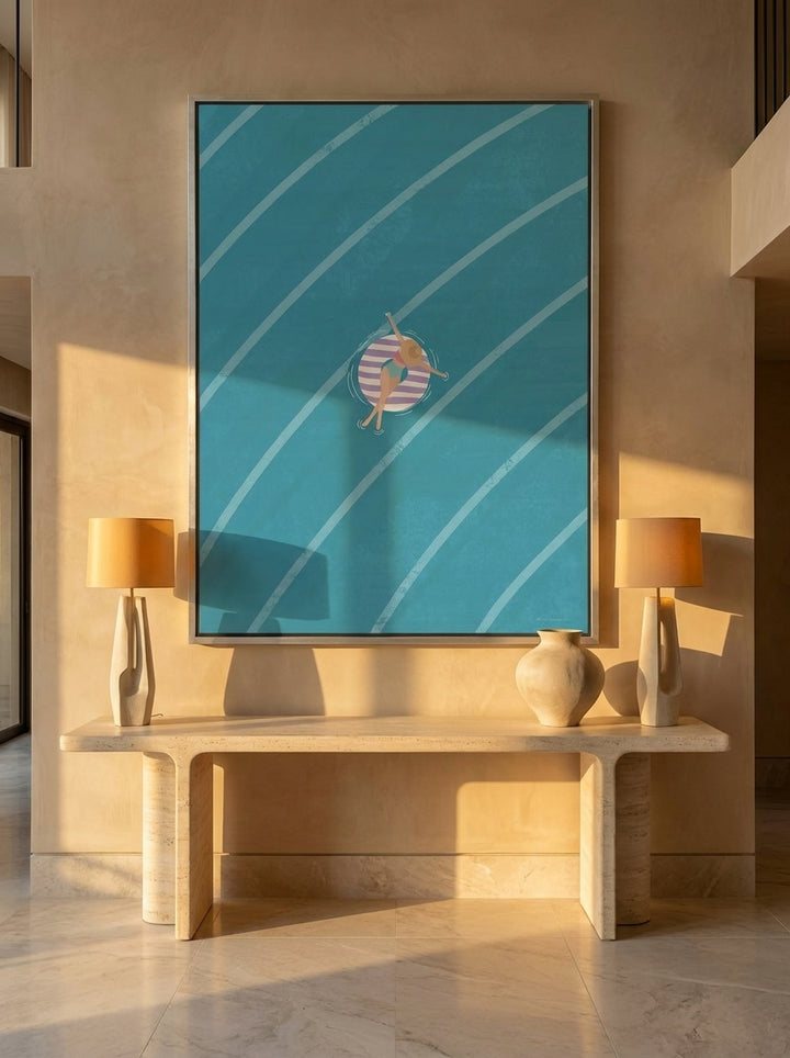 Oversized statement canvas wall art with a silver leaf surround styled on the wall in a luxe living room