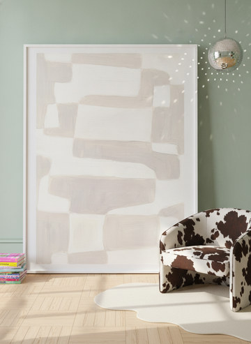 Oversized statement modern wall art print leaning against the wall in a colourful eclectic bedroom