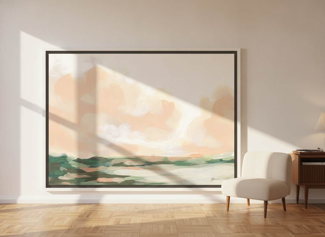 Oversized statement canvas wall art with a white surround leaning against the wall in a mid-century dining room