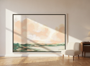 Oversized statement canvas wall art with a white surround leaning against the wall in a mid-century dining room