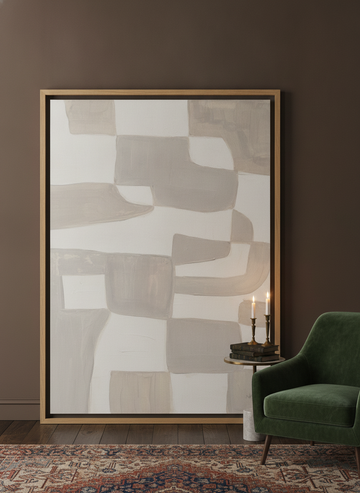 Oversized statement canvas wall art with a natural timber surround leaning against the wall in a moody bedroom