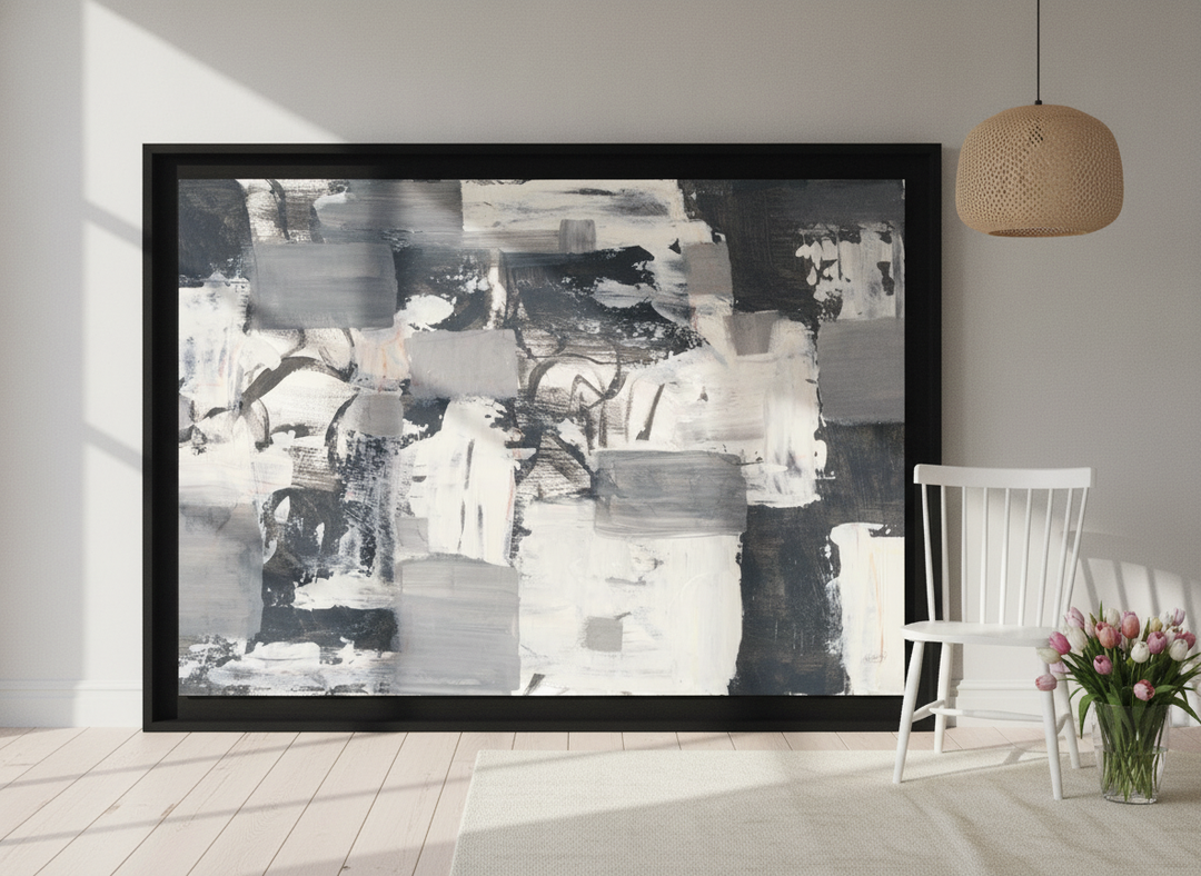 Oversized statement modern wall art print leaning against the wall in a bright Scandinavian dining room