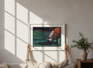 Person holding canvas wall art with a white surround in a Mediterranean living room