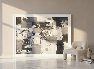 Oversized statement modern wall art print leaning against the wall in a luxe bedroom