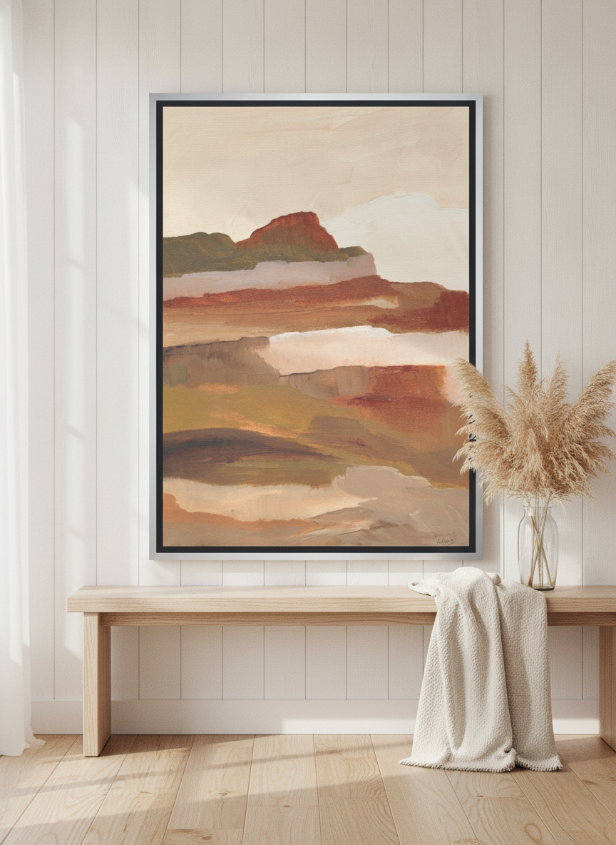 Canvas wall art with a silver leaf surround standing on a console in a coastal bedroom