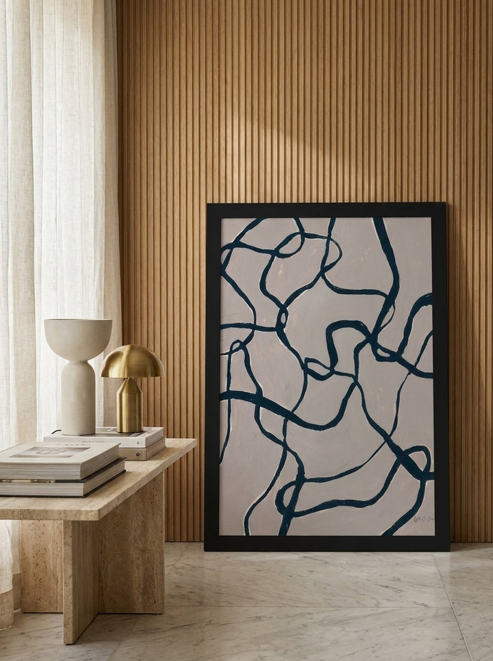 Modern wall art print leaning against the wall in a luxe living room