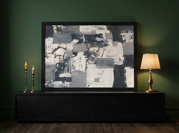 Modern wall art print standing on a console in a moody home office