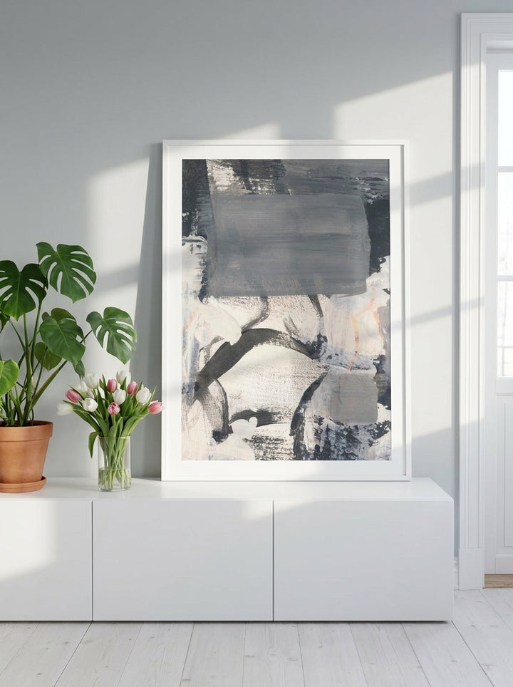 Modern wall art print standing on a sideboard in a bright Scandinavian home office