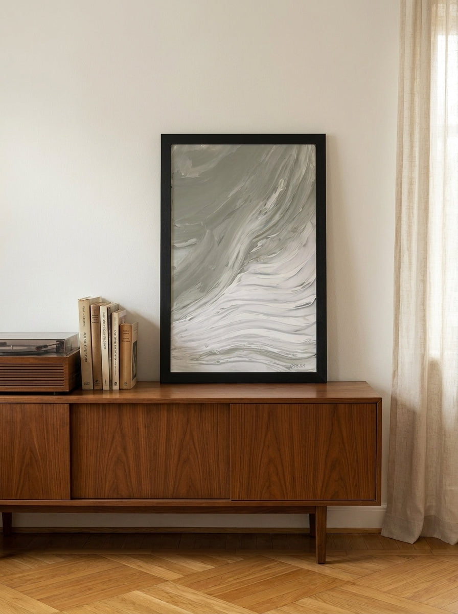 Modern wall art print standing on a sideboard in a mid-century living room