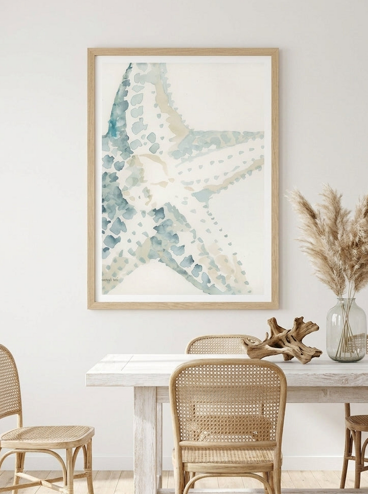 Modern wall art print styled on the wall in a coastal dining room