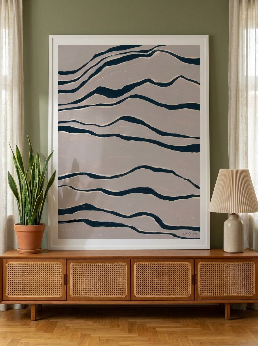 Modern wall art print standing on a sideboard in a mid-century home office