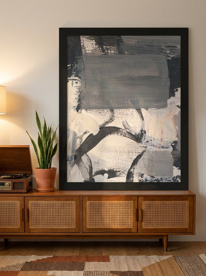Modern wall art print standing on a sideboard in a mid-century living room