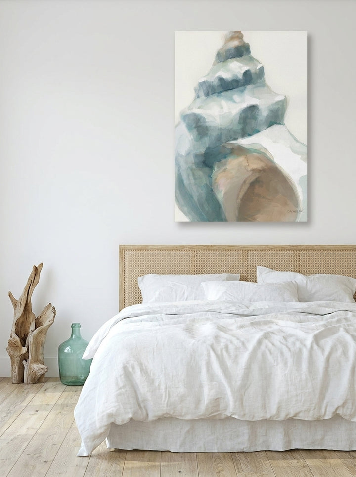 Stretched canvas wall art styled on the wall in a coastal bedroom