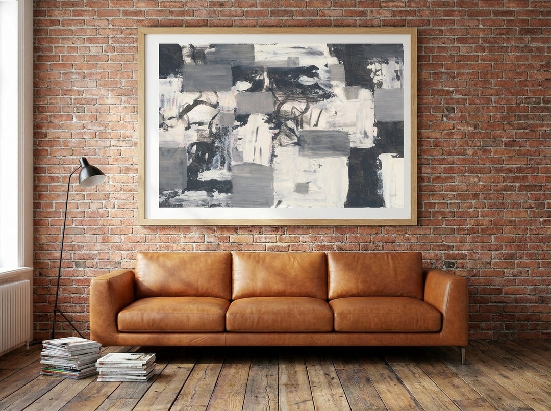 Modern wall art print styled on the wall in an industrial loft living room