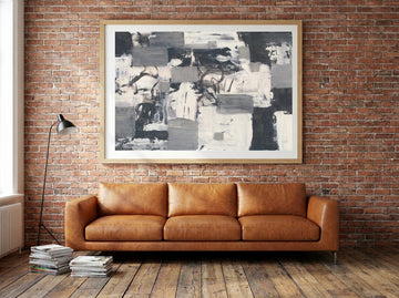 Modern wall art print styled on the wall in an industrial loft living room