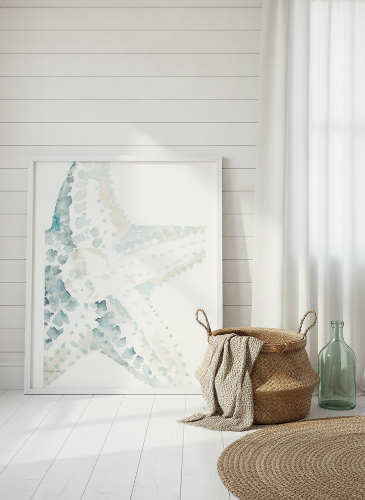 Oversized statement modern wall art print leaning against the wall in a coastal bedroom