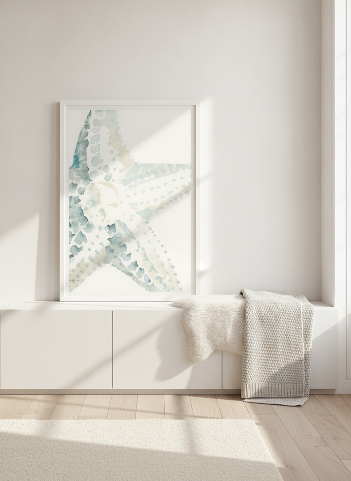 Modern wall art print standing on a sideboard in a bright Scandinavian bedroom
