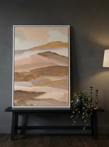Canvas wall art with a white surround standing on a console in a moody bedroom