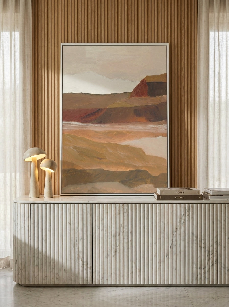 Canvas wall art with a white surround standing on a sideboard in a luxe living room