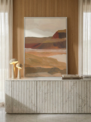 Canvas wall art with a white surround standing on a sideboard in a luxe living room
