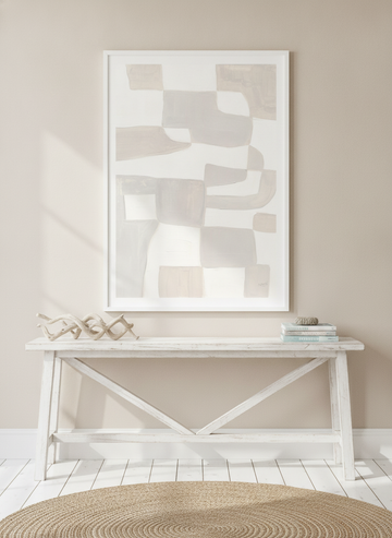 Modern wall art print standing on a console in a coastal bathroom